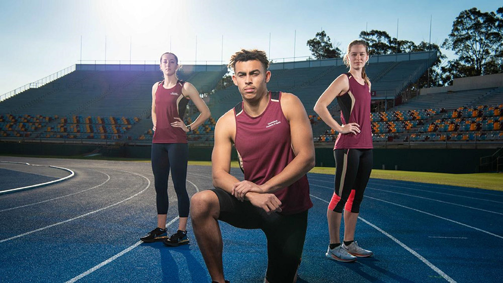 Image of three athletes on a running track